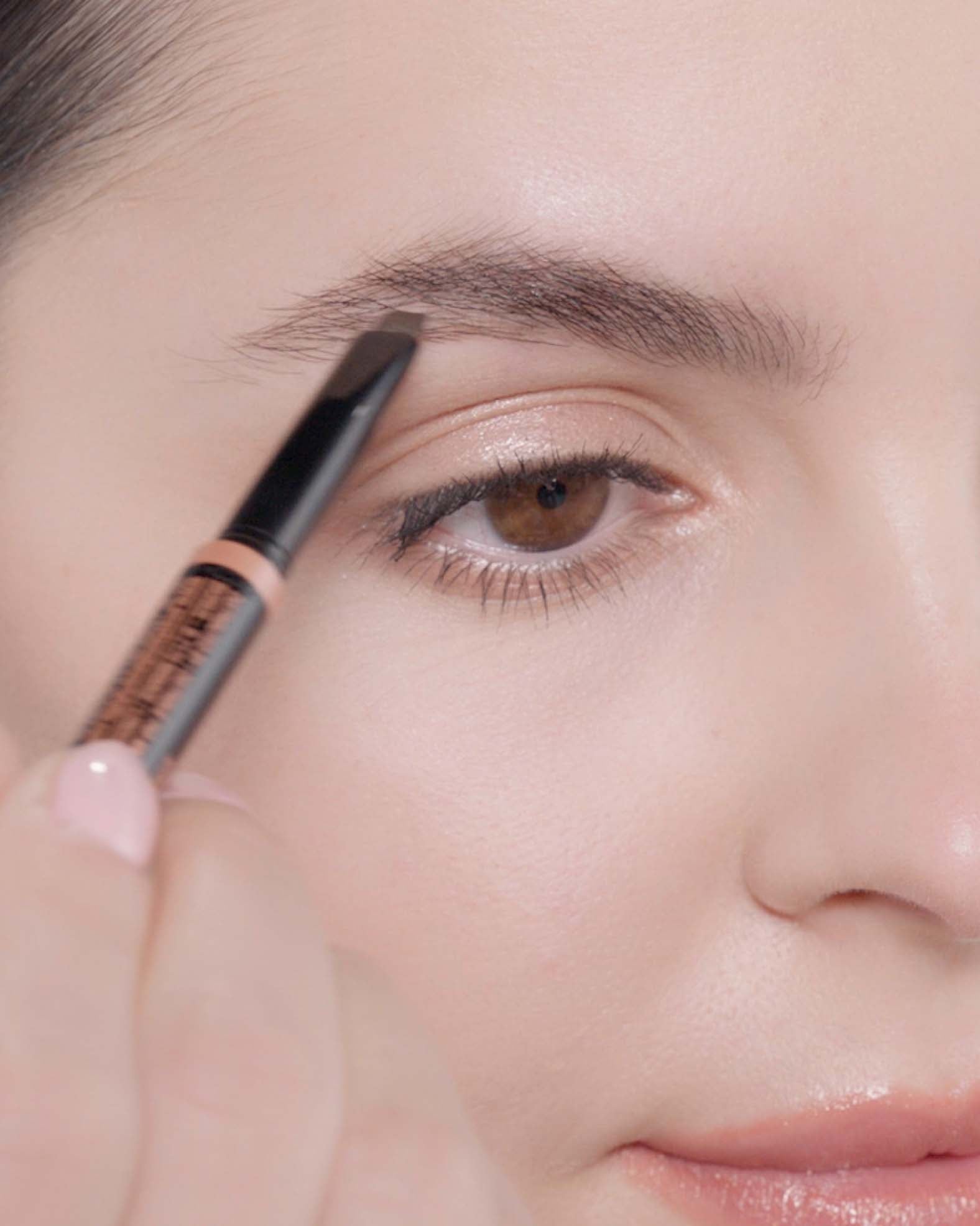 Applying Brow Definer in Dark Brown and Brow Freeze® Gel